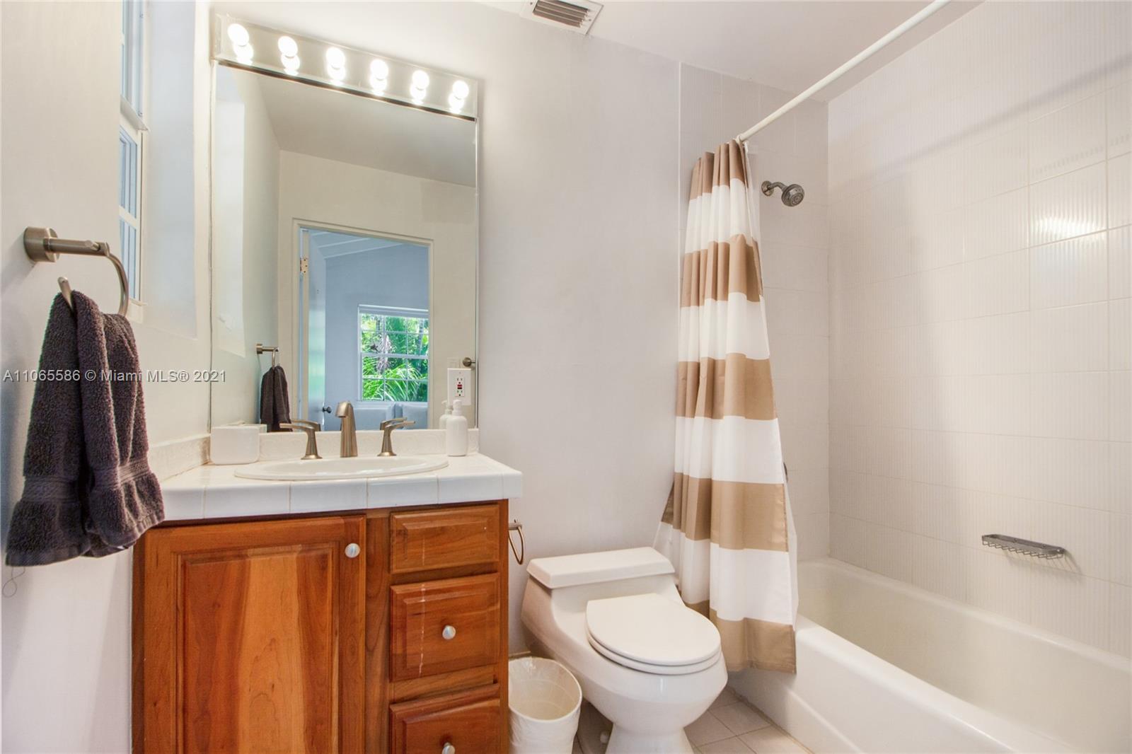1701 Micanopy Avenue Miami, FL 33133 - Photo 26 of 40 a bathroom with a sink a toilet and shower