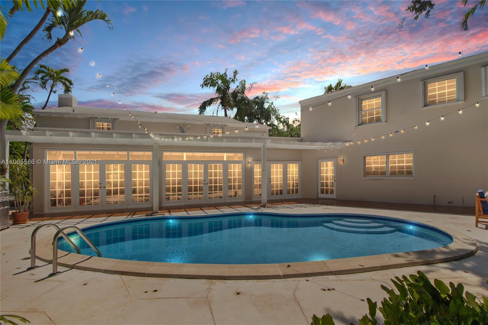 1701 Micanopy Avenue Miami, FL 33133 - Photo 30 of 40 a view of a room with wooden floor and a potted plant