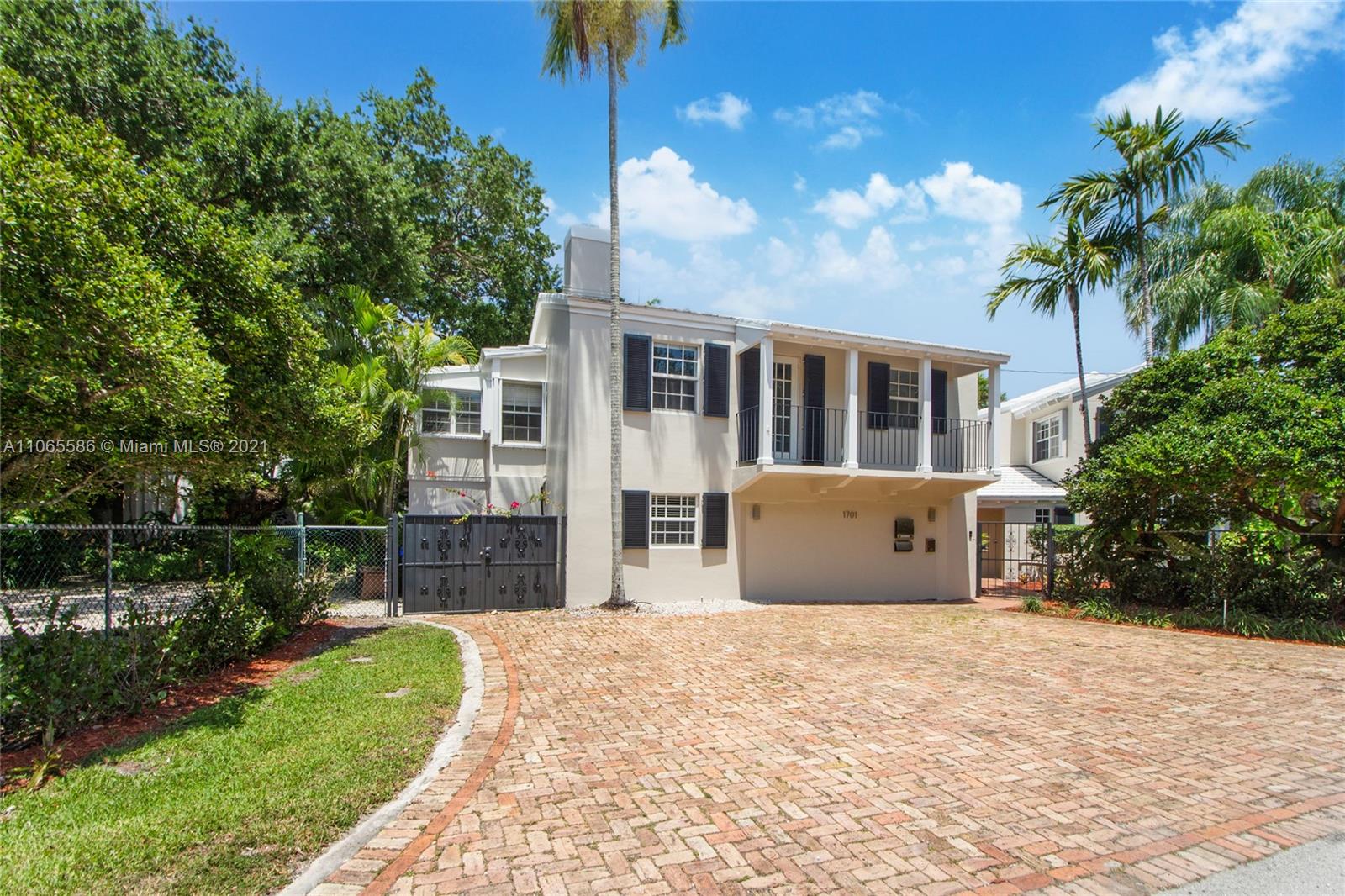 1701 Micanopy Avenue Miami, FL 33133 - Photo 3 of 40 a front view of a house with a garden and yard