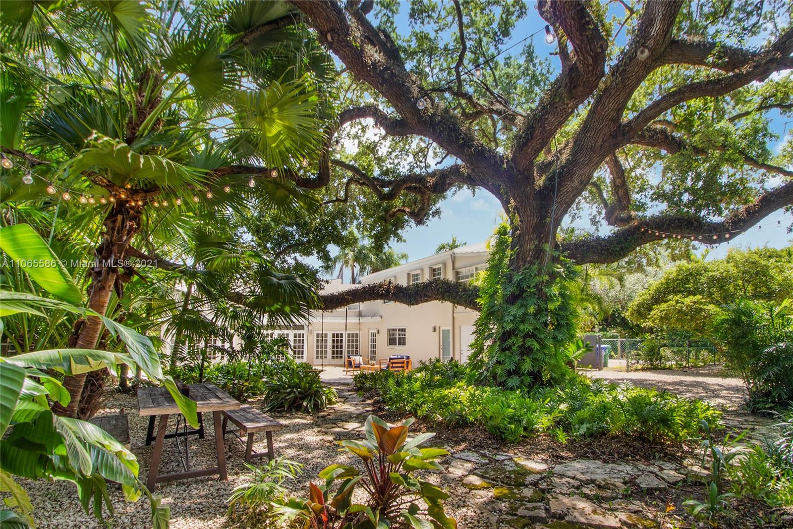 1701 Micanopy Avenue Miami, FL 33133 - Photo 36 of 40 a view of a house with a tree in a yard