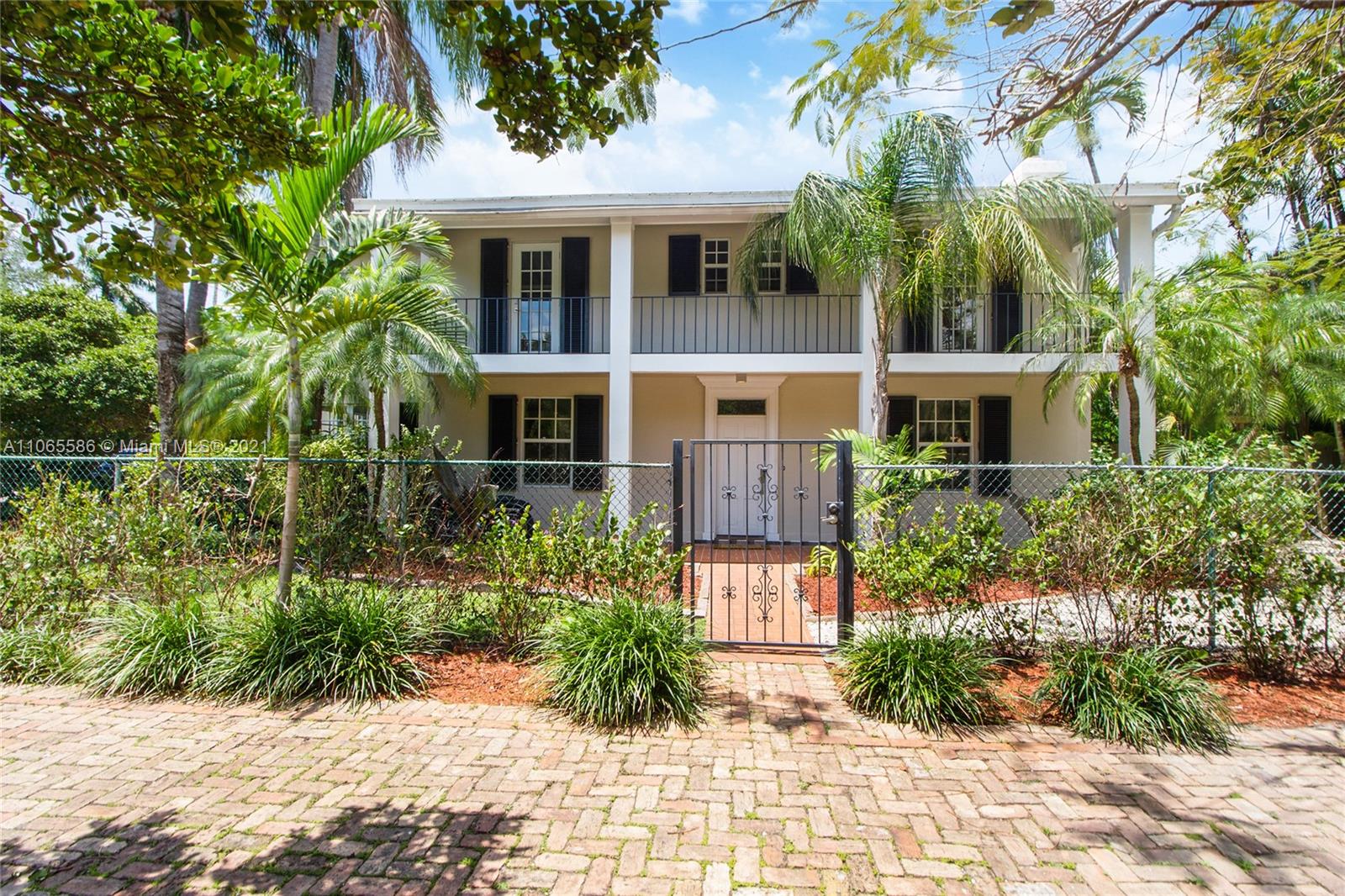 1701 Micanopy Avenue Miami, FL 33133 - Photo 4 of 40 a front view of a house with a yard