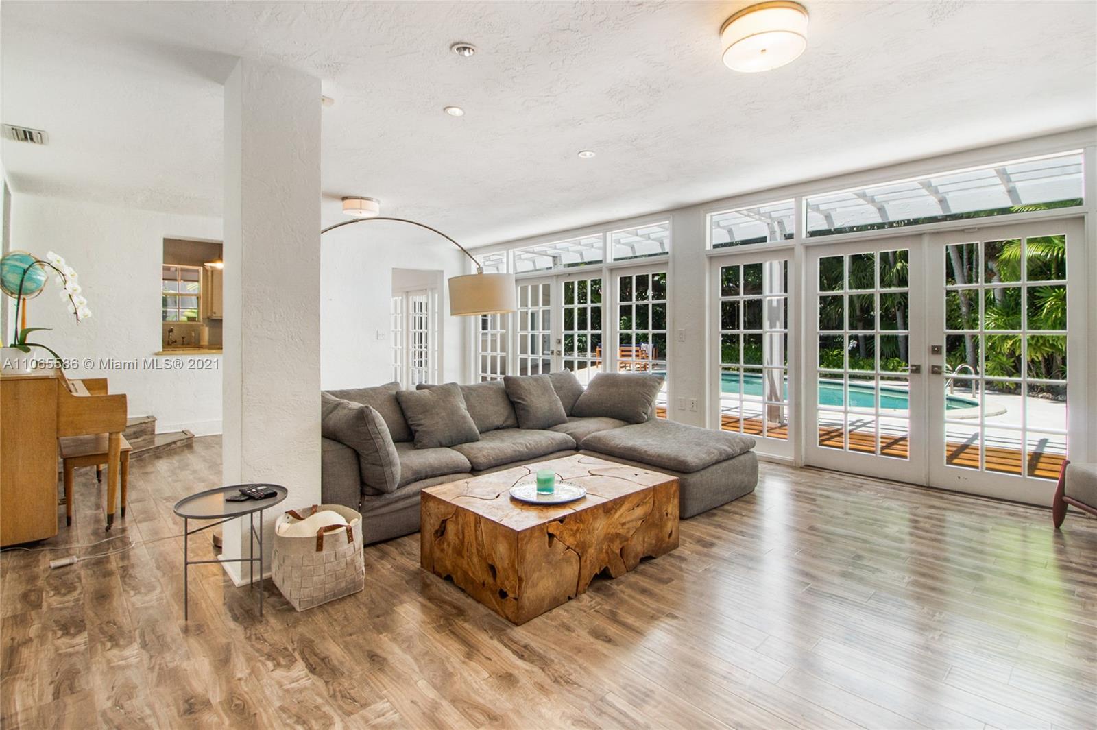 1701 Micanopy Avenue Miami, FL 33133 - Photo 8 of 40 a living room with furniture and a large window