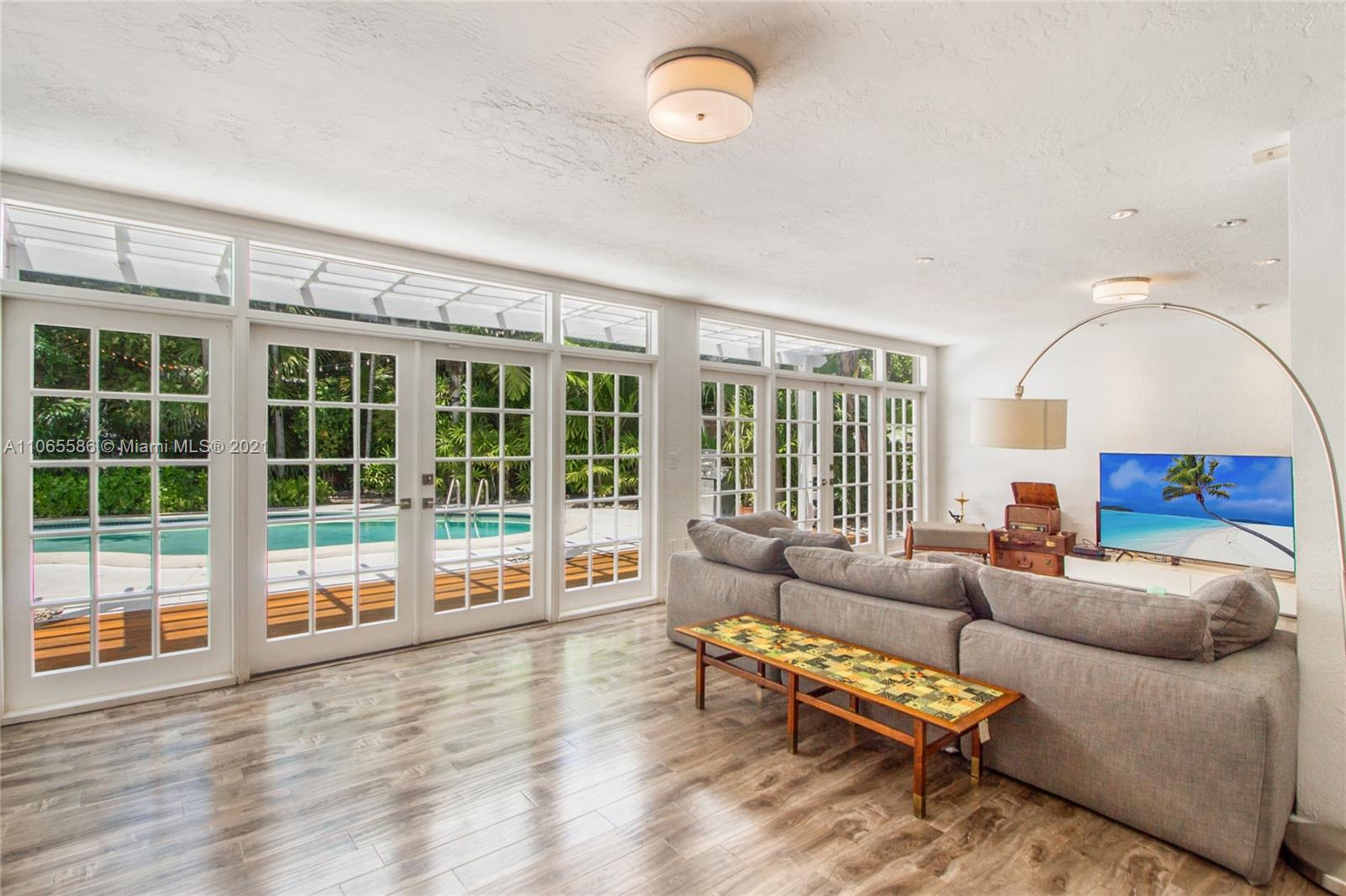 1701 Micanopy Avenue Miami, FL 33133 - Photo 9 of 40 a living room with furniture and a large window