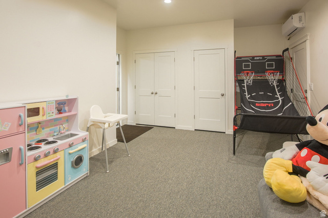 910 South 1700 West Layton, UT 84041 - Photo 22 of 26 Playroom with a wall mounted mini split and dark colored carpet