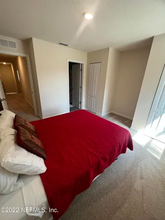 a blue bed sitting in a bedroom next to a window