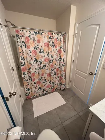 a view of bathroom with shower and toilet