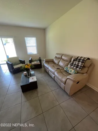 a living room with furniture and gym equipment