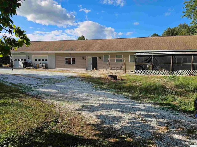 a front view of house with yard and trees