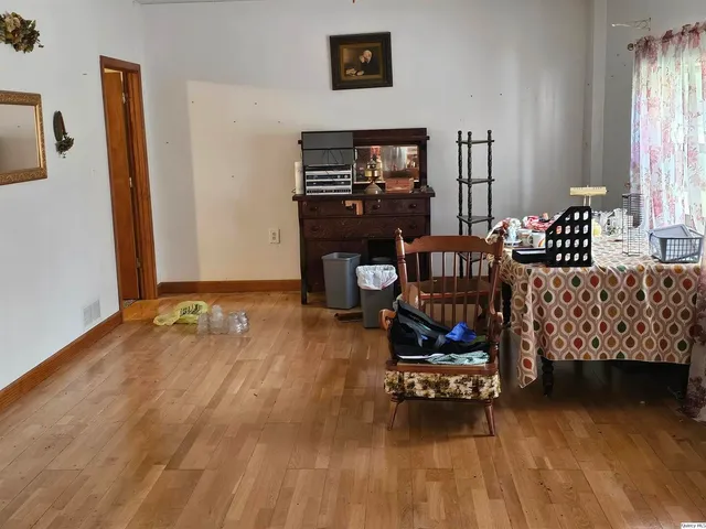 a bedroom with furniture and a wooden floor