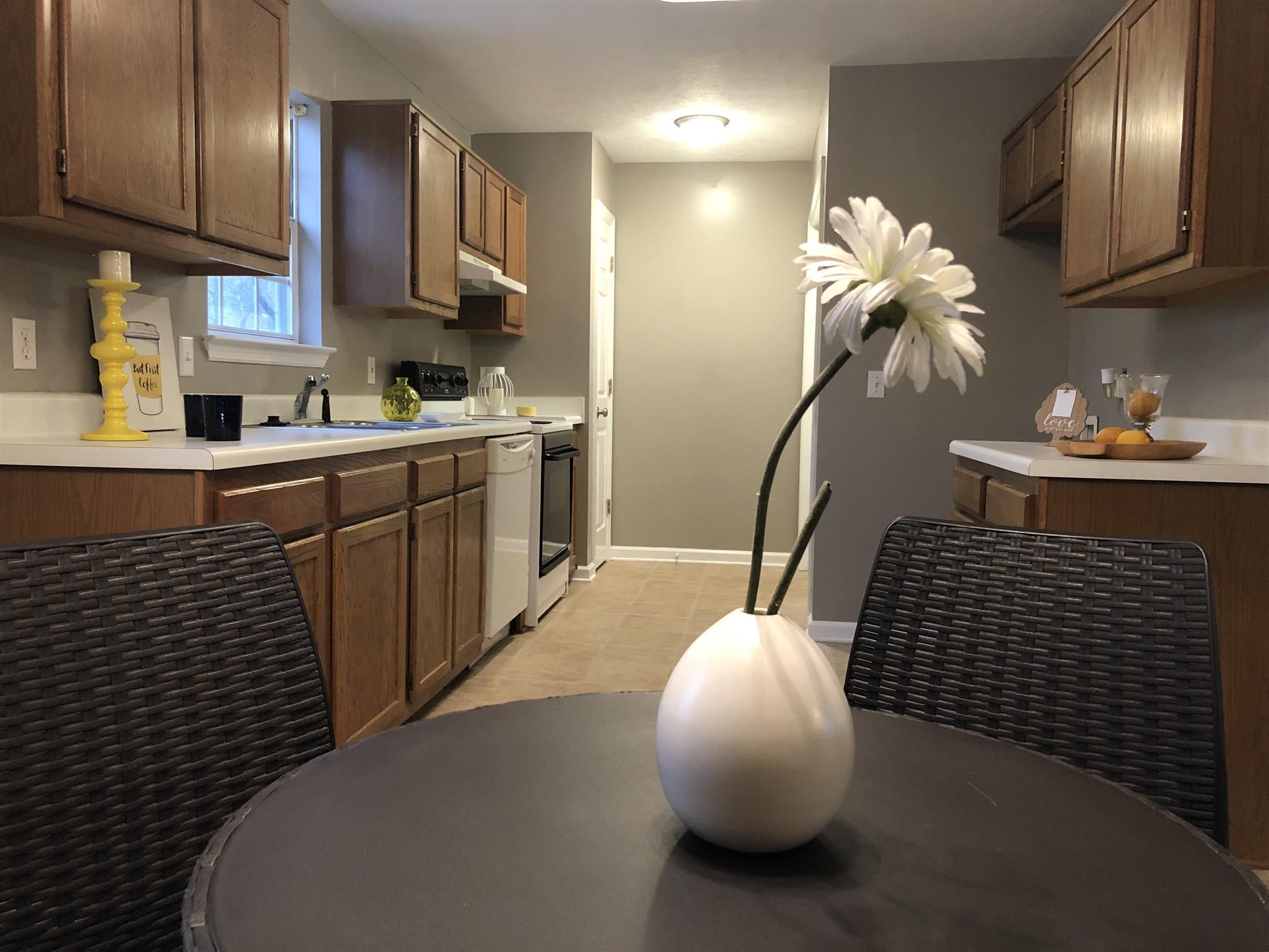 a kitchen with granite countertop a sink stainless steel appliances and cabinets
