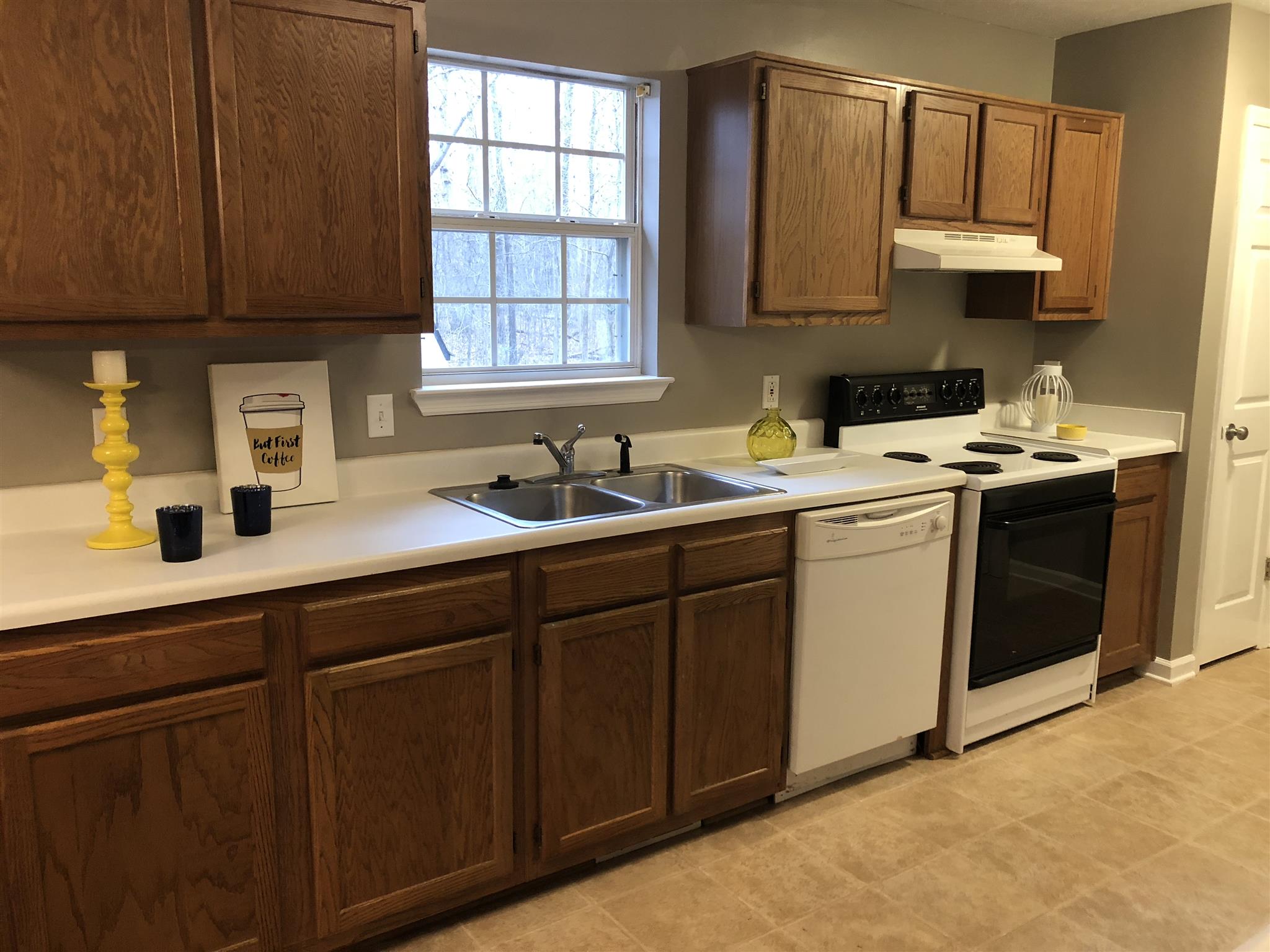 140 Gaskins Road Dickson, TN 37055 - Photo 11 of 27 a kitchen with stainless steel appliances granite countertop a sink stove and cabinets