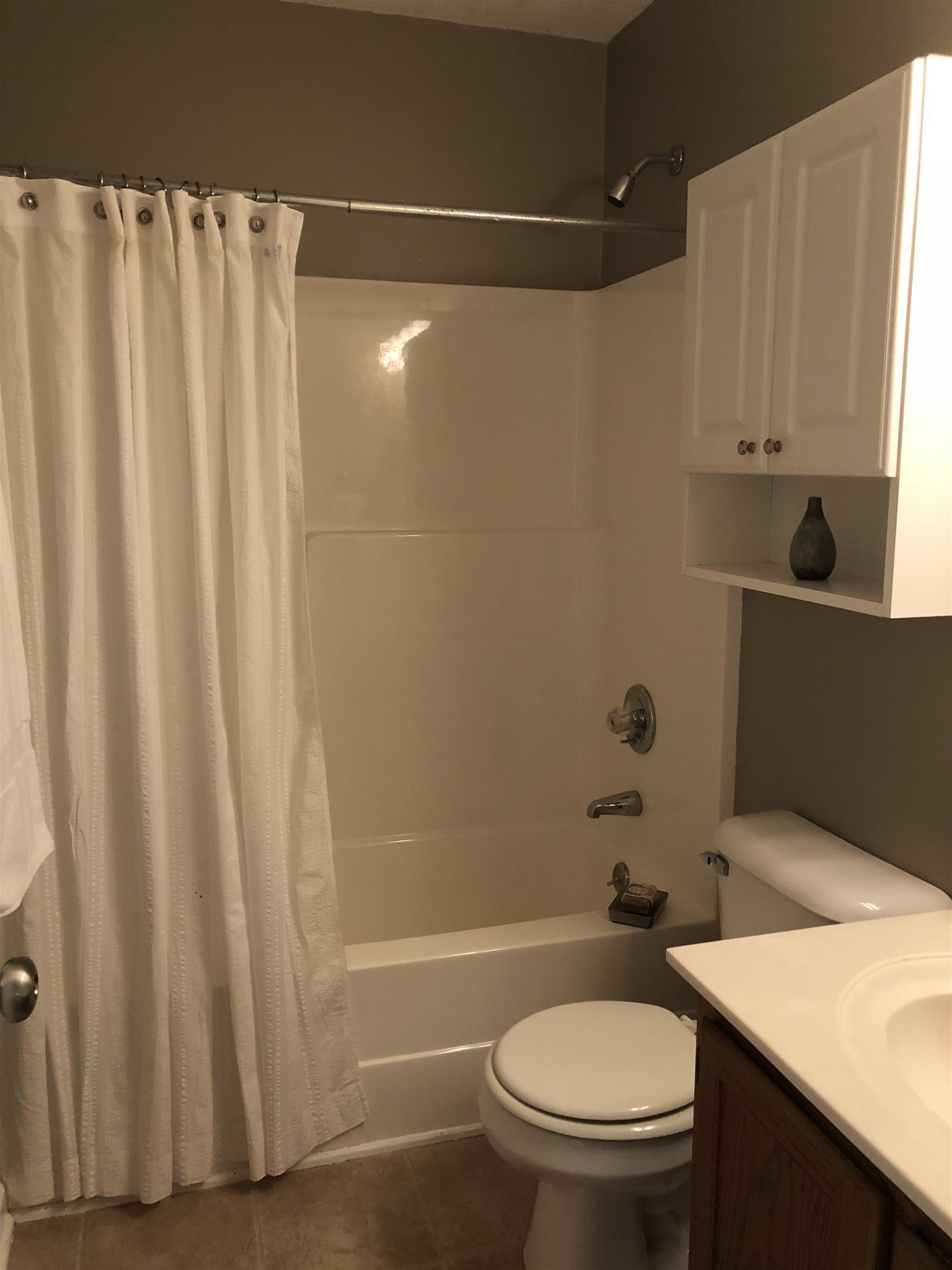 140 Gaskins Road Dickson, TN 37055 - Photo 18 of 27 a bathroom with a sink a toilet and shower