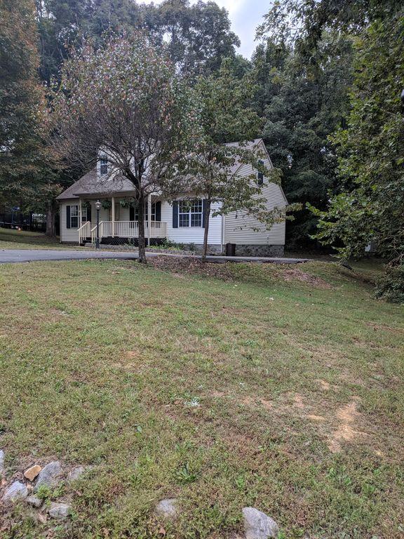 140 Gaskins Road Dickson, TN 37055 - Photo 3 of 27 a front view of a house with a garden and trees