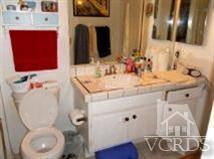 6525 Stoney View Lane, Unit 4 Simi Valley, CA 93063 - Photo 5 of 9 a bathroom with a toilet sink and mirror