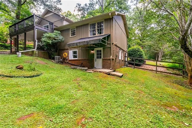 a view of a house with a yard and sitting area