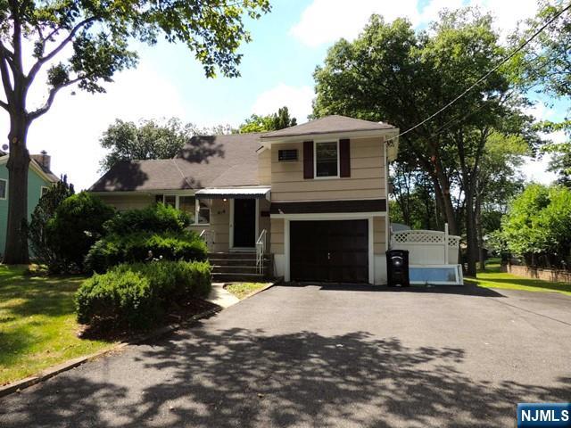 a view of a house with a yard and tree s