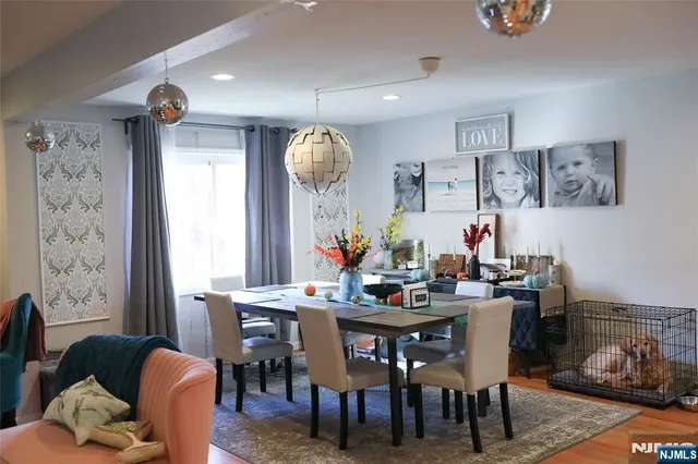 a view of a dining room with furniture and a chandelier