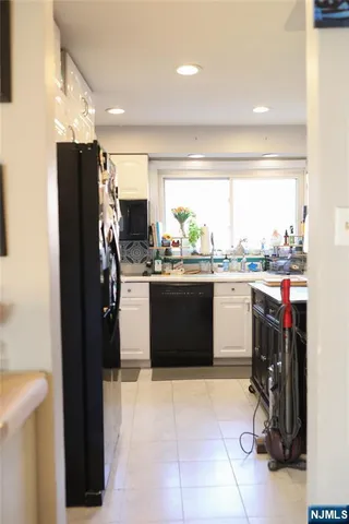 a kitchen with a sink appliances and cabinets