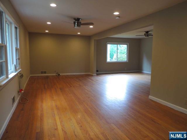 375 Chelsea Street Paramus, NJ 07652 - Photo 2 of 19 an empty room with wooden floor and windows