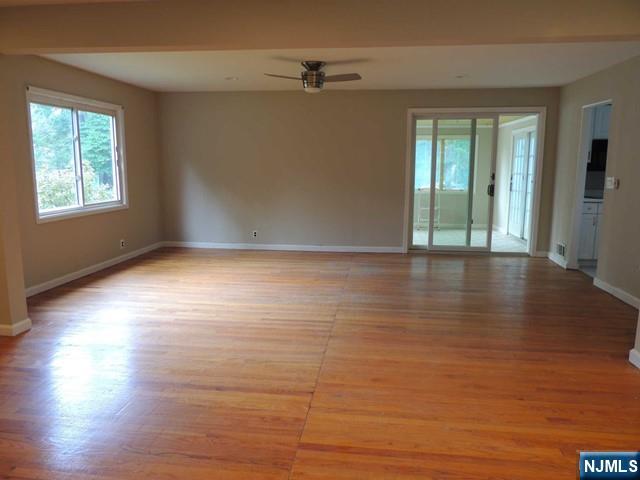 375 Chelsea Street Paramus, NJ 07652 - Photo 3 of 19 a view of an empty room with wooden floor and a window