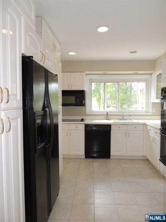 375 Chelsea Street Paramus, NJ 07652 - Photo 4 of 19 a large kitchen with a large window and stainless steel appliances