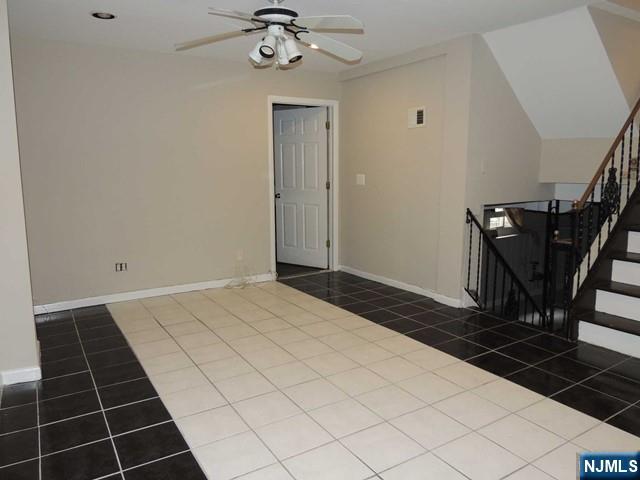 375 Chelsea Street Paramus, NJ 07652 - Photo 6 of 19 a bedroom with a bed and a chandelier