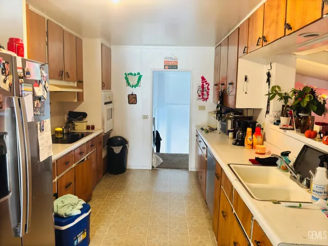 a kitchen with stainless steel appliances a sink and a refrigerator
