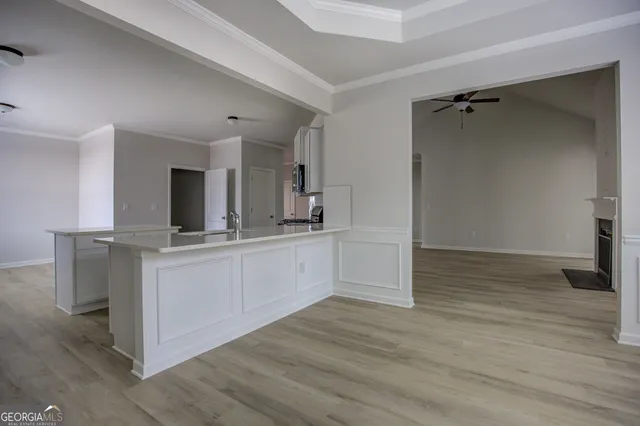 a view of a kitchen counter space with wooden floor