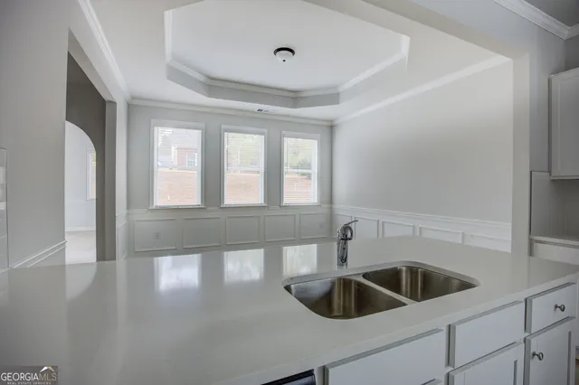 a kitchen with a sink and refrigerator