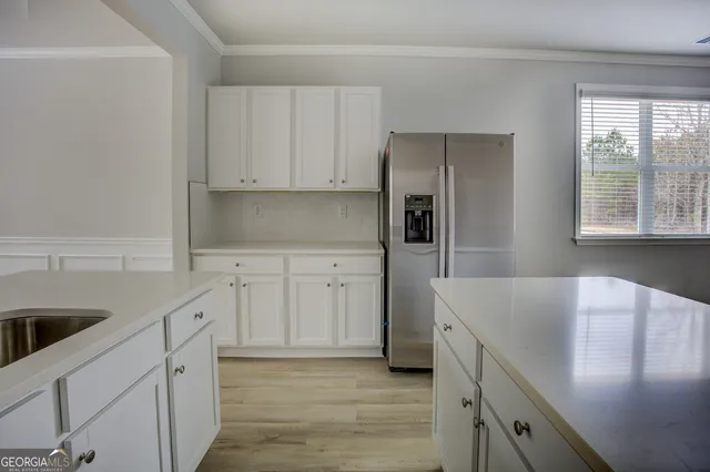 a kitchen with granite countertop a sink a stove and refrigerator