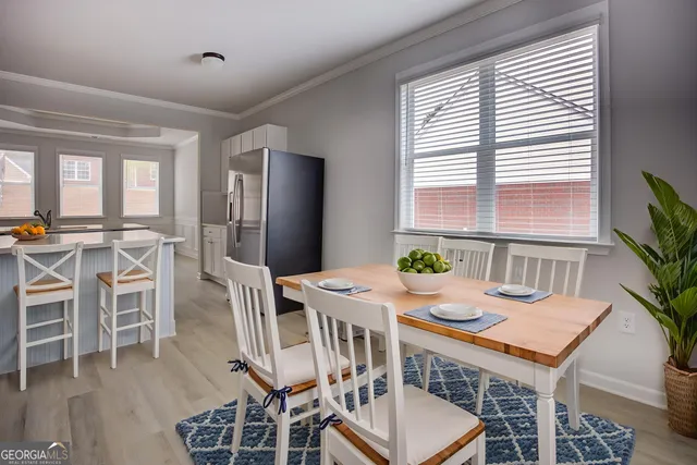 a view of a dining room with furniture and window