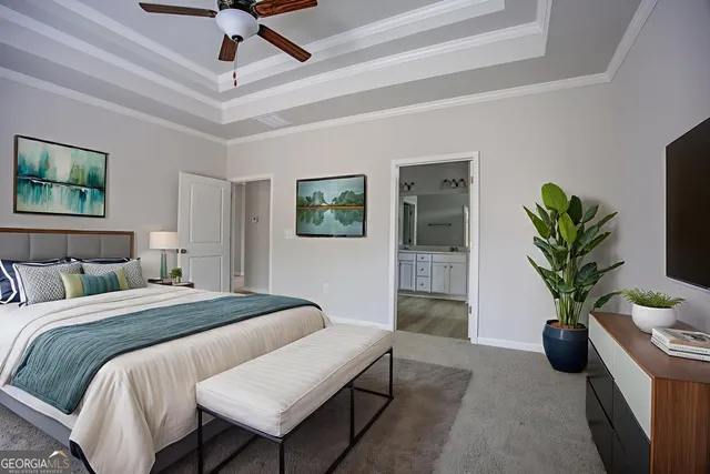 a bedroom with a large bed and a potted plant