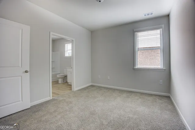 an empty room with windows and closet
