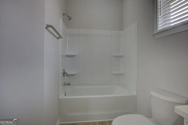 a bathroom with a bathtub and a toilet