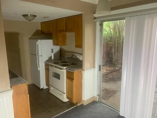 a kitchen with a stove and a refrigerator