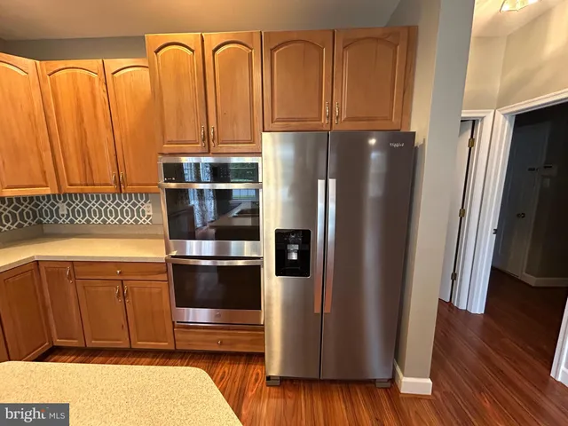 a kitchen with stainless steel appliances granite countertop a refrigerator and a sink