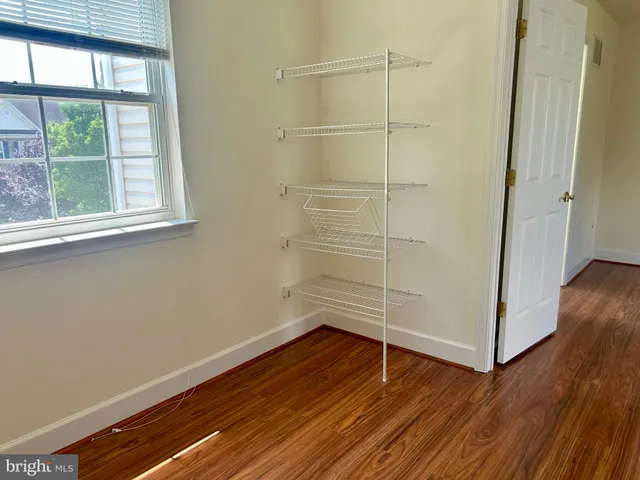 a room with wooden floor and window