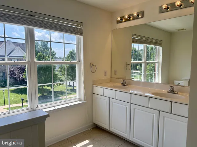a bathroom with a sink and a window