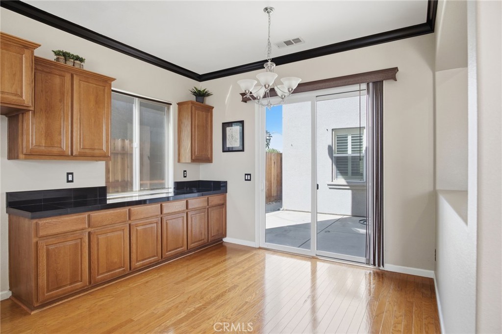 4822 Durant Way Merced, CA 95348 - Photo 11 of 48 a large kitchen with granite countertop a refrigerator and a sink