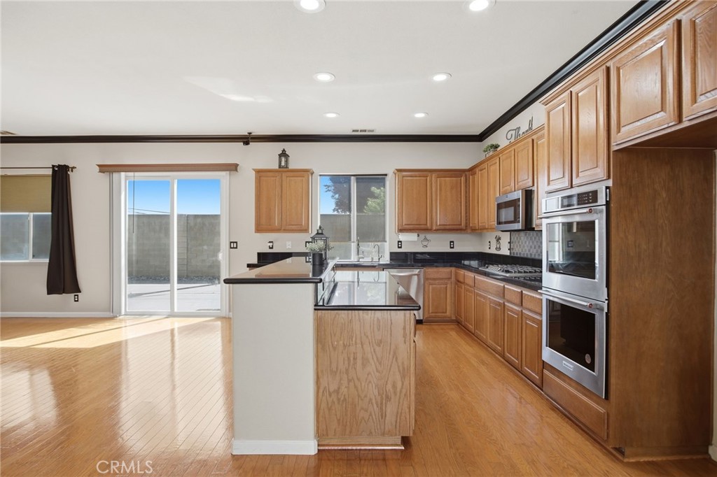 4822 Durant Way Merced, CA 95348 - Photo 12 of 48 a kitchen with stainless steel appliances granite countertop a stove a sink and a refrigerator