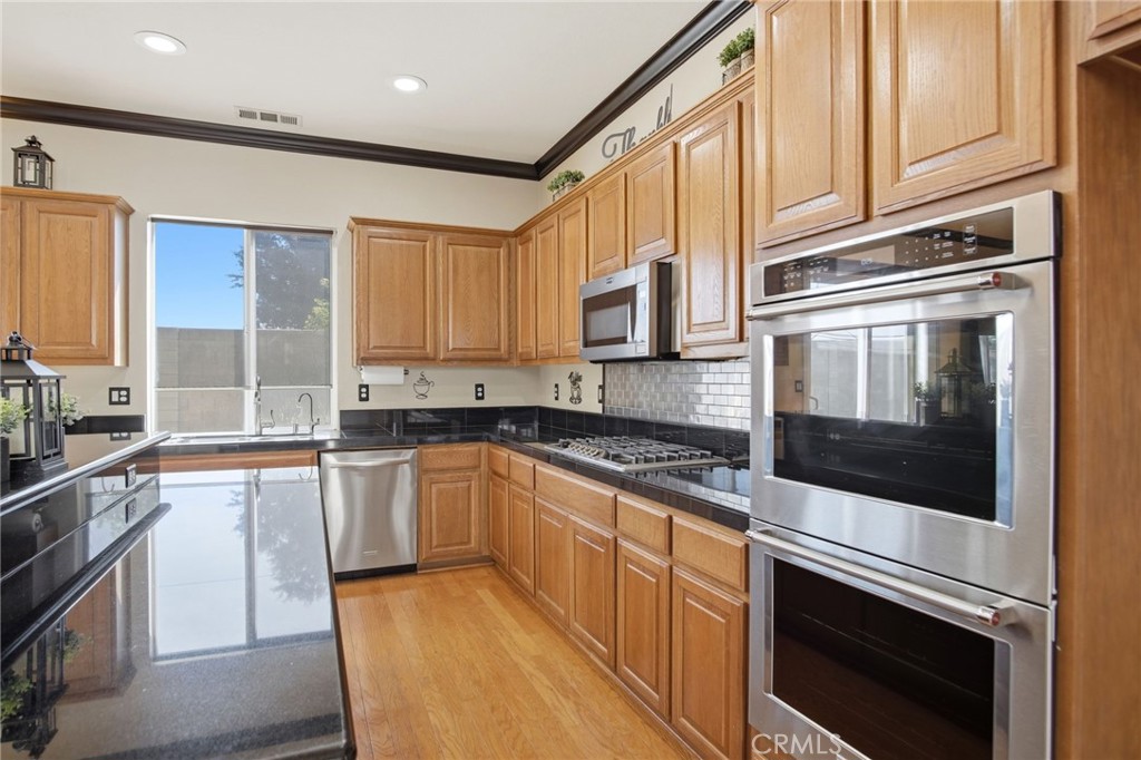 4822 Durant Way Merced, CA 95348 - Photo 13 of 48 a kitchen with stainless steel appliances granite countertop a stove microwave and cabinets