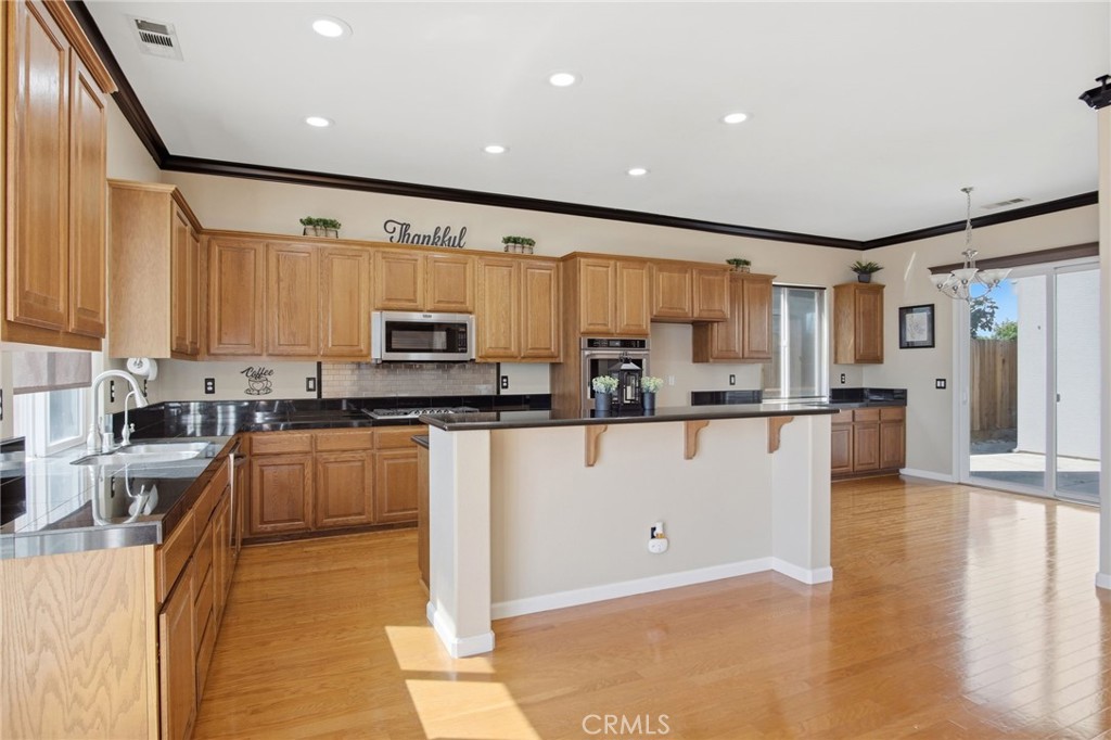 4822 Durant Way Merced, CA 95348 - Photo 14 of 48 a kitchen with stainless steel appliances granite countertop a refrigerator sink and cabinets