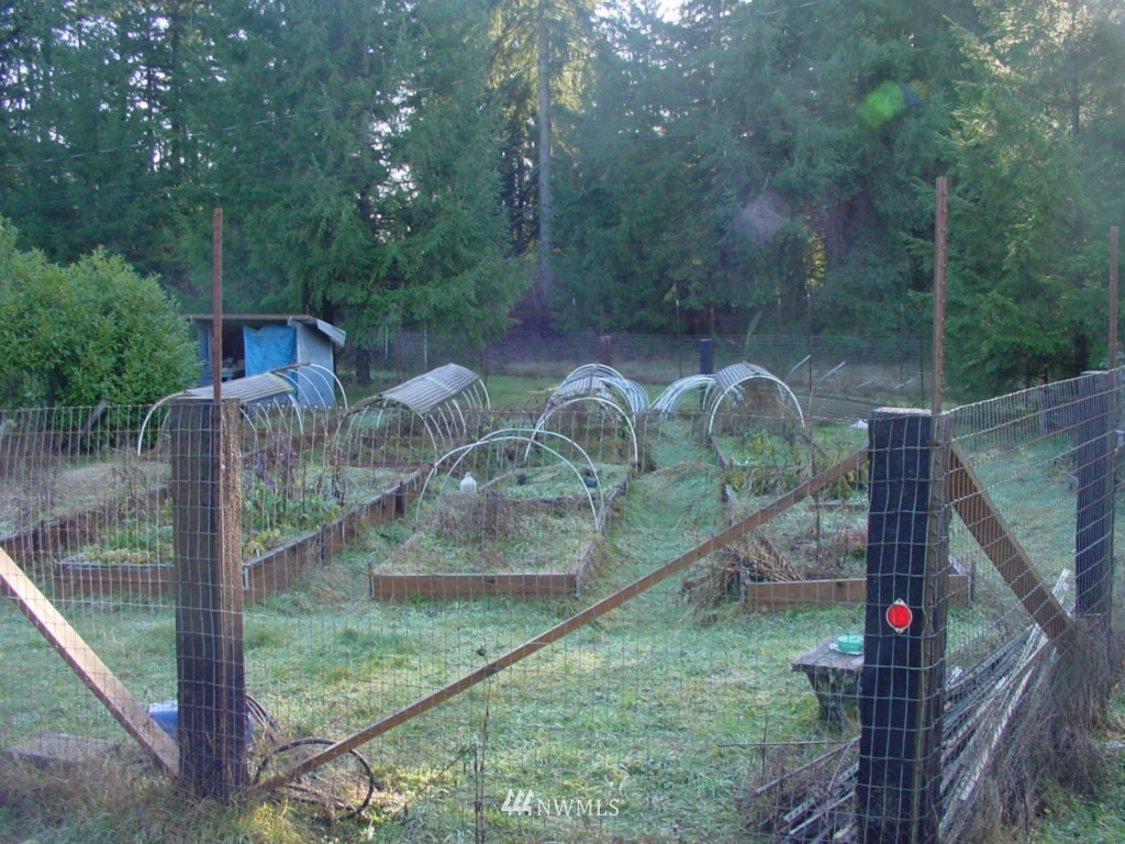 5740 133rd Avenue Southwest Rochester, WA 98579 - Photo 5 of 10 a backyard of a house with table and chairs