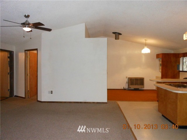 5740 133rd Avenue Southwest Rochester, WA 98579 - Photo 7 of 10 a view of a kitchen with a sink and a refrigerator