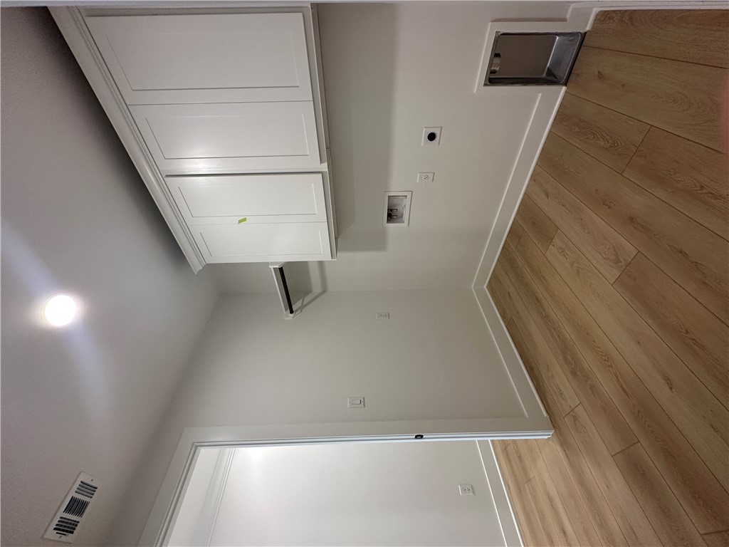4302 Conestogo Court Bryan, TX 77802 - Photo 12 of 34 a view of a kitchen with wooden floor and cabinets