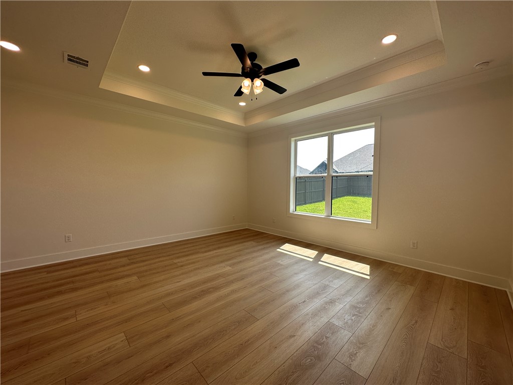 4302 Conestogo Court Bryan, TX 77802 - Photo 13 of 34 an empty room with wooden floor and windows