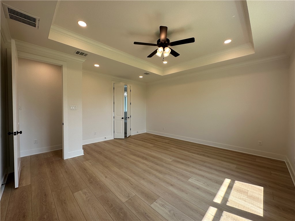 4302 Conestogo Court Bryan, TX 77802 - Photo 14 of 34 a view of empty room with wooden floor and fan