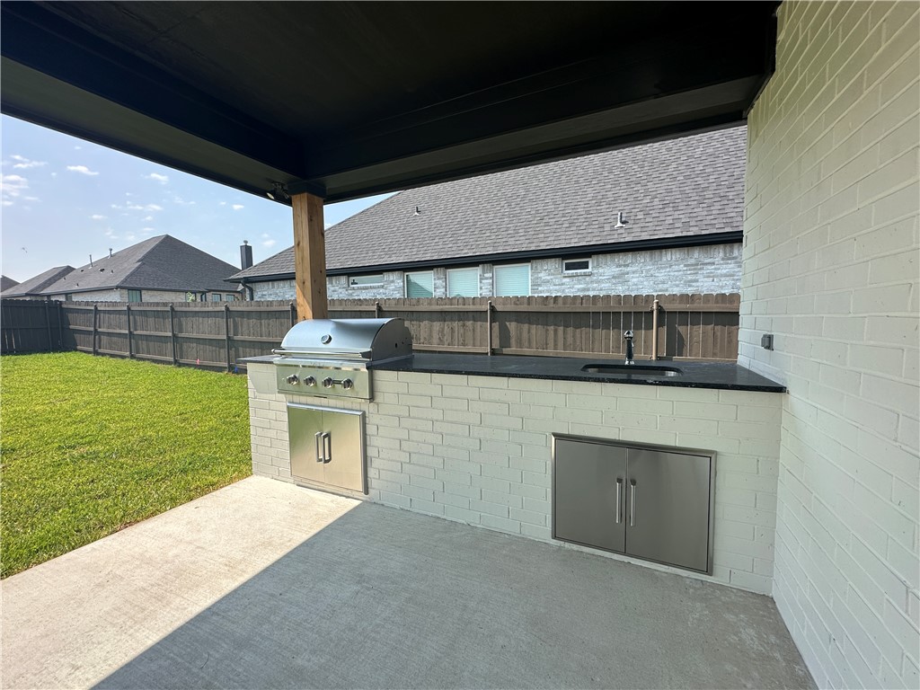 4302 Conestogo Court Bryan, TX 77802 - Photo 16 of 34 a kitchen with a stove and a microwave