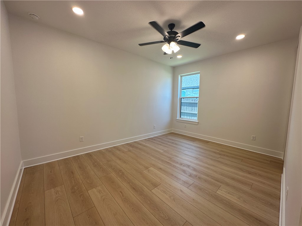 4302 Conestogo Court Bryan, TX 77802 - Photo 20 of 34 an empty room with wooden floor and windows
