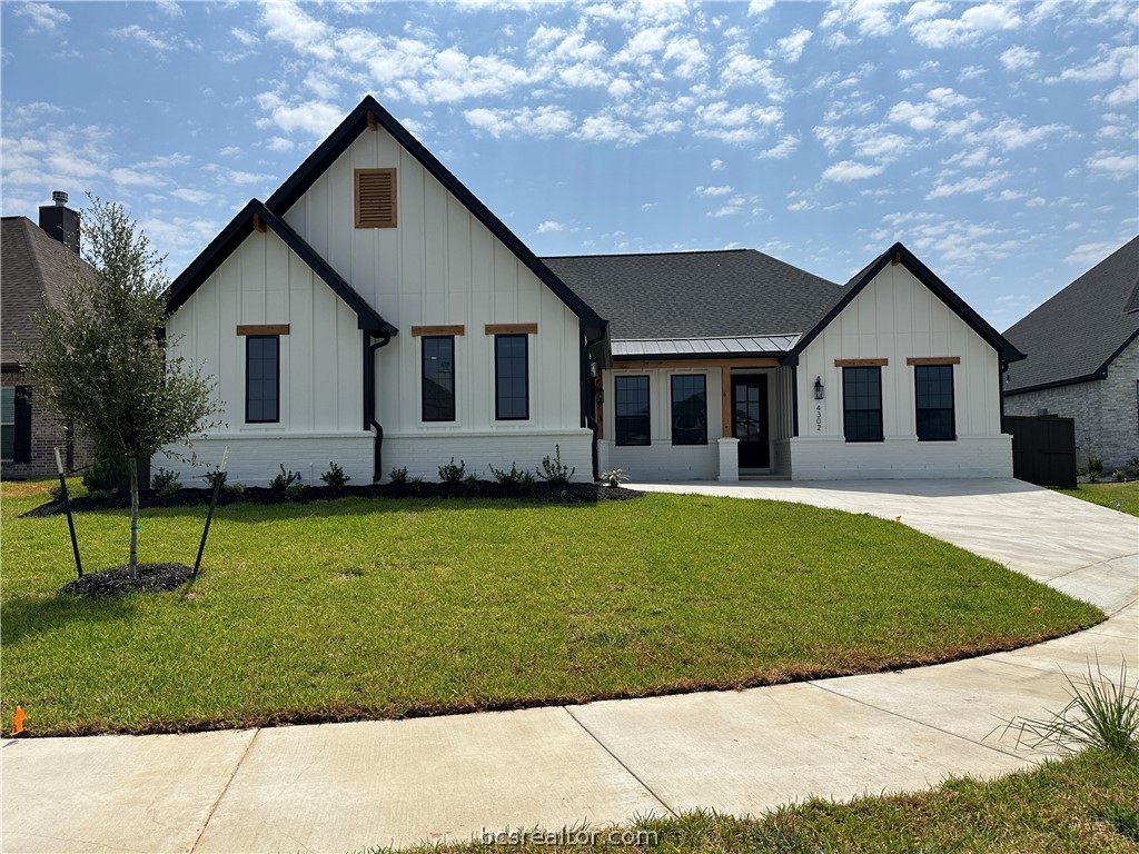 4302 Conestogo Court Bryan, TX 77802 - Photo 2 of 34 a front view of a house with a garden